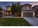 Two story house exterior at dusk with landscaped yard at 2263 S Loveland St, Denver, CO 80228