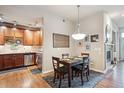 Bright dining area with hardwood floors and kitchen access at 7865 Vallagio Ln # 207, Englewood, CO 80112