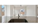 Modern kitchen with sink overlooking backyard at 857 Sawdust Dr, Brighton, CO 80601