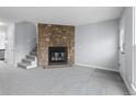 Living room featuring a cozy stone fireplace and neutral color palette at 14314 E Hawaii Cir # D, Aurora, CO 80012