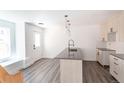 Modern kitchen with light wood cabinets, dark countertops, and an island at 1570 N Gilpin St, Denver, CO 80218