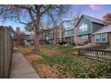 Rear view of townhomes with green space and trees at 5425 S Delaware St, Littleton, CO 80120