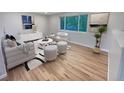 Virtually staged living room with hardwood floors at 418 S Victor Way, Aurora, CO 80012