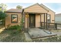 A beige ranch house with a covered porch and ramp at 7261 Magnolia St, Commerce City, CO 80022