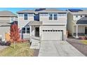 Two-story house with attached garage and solar panels at 244 Chipeta Way, Lochbuie, CO 80603