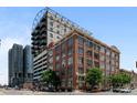 Brick building exterior with modern addition; city street view at 2000 Arapahoe St # 405, Denver, CO 80205