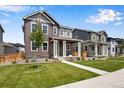 Two-story home with modern exterior and landscaped front yard at 17831 Parkside N Dr, Commerce City, CO 80022