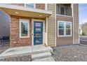 Stylish front entrance with a blue door and stone accents at 3574 Corsica Way, Castle Rock, CO 80109