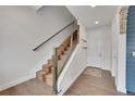 Modern staircase with wood and metal accents, and unique runner at 3574 Corsica Way, Castle Rock, CO 80109