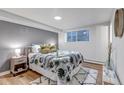 Bright bedroom with a comfortable bed and leafy patterned bedding at 3047 W 47Th Ave # 105, Denver, CO 80211