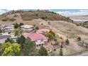 Luxury home nestled on a hillside overlooking a lake at 6321 Spotted Fawn Run, Littleton, CO 80125