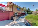 House exterior showcasing steps, landscaping, and a red garage door at 9350 Grandview Ave, Arvada, CO 80002