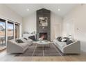 Spacious living room with fireplace and access to backyard at 8015 Parnassus Pl, Castle Rock, CO 80108