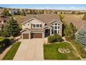 Two-story house with a large backyard and beautiful landscaping at 5175 Mining Camp Trl, Parker, CO 80134