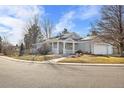 Inviting home exterior with a covered porch and a paved walkway at 98 Risse Ct, Erie, CO 80516