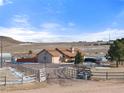 Ranch-style home on spacious lot with wooden fence and mountain views at 12154 Mesa View Rd, Larkspur, CO 80118