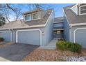 Front view of a gray townhouse with walkway and landscaping at 8099 S Trinchera Peak, Littleton, CO 80127