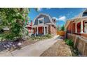 House exterior with a gabled roof and landscaped yard at 638 S Lincoln St, Denver, CO 80209
