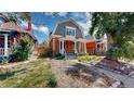 Brick home with a gabled roof and landscaped front yard at 638 S Lincoln St, Denver, CO 80209