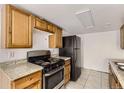 Simple kitchen with wood cabinets and stainless steel appliances at 14543 E 12Th Ave, Aurora, CO 80011