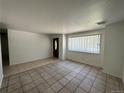 Bright living room featuring tile floors and a large window at 12154 E Virginia Dr, Aurora, CO 80012