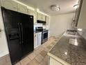 Galley kitchen with granite countertops and stainless steel appliances at 12154 E Virginia Dr, Aurora, CO 80012