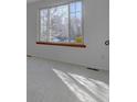 Bright living room with carpet and large window at 7168 S Cody Way, Littleton, CO 80128