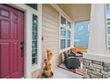 Inviting front porch with seating area and potted plants at 4689 Moondust Pl, Castle Rock, CO 80109