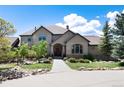 Two-story home with landscaping and a welcoming front entrance at 2916 Hiwall Ct, Castle Rock, CO 80109