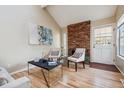 Bright living room with hardwood floors and a brick fireplace at 2901 W Long Dr # G, Littleton, CO 80120