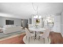 Bright dining area with a round table, chairs, and an open concept to the living room at 3465 S Poplar St # 308, Denver, CO 80224