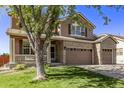 Two-story house with brown siding, brick accents, and a large front yard at 11533 Dahlia St, Thornton, CO 80233