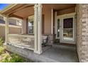 Inviting front porch with seating and a view of the front yard at 11533 Dahlia St, Thornton, CO 80233
