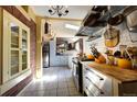 Open kitchen with butcher block countertops, exposed brick, and ample storage at 1339 Quince St, Denver, CO 80220