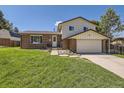 Brick ranch house with attached garage and landscaped lawn at 7993 S Jay Dr, Littleton, CO 80128