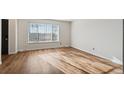 Bright living room featuring hardwood floors and large window at 8737 Santa Fe Dr, Thornton, CO 80260