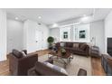 Living room with brown leather furniture and large windows at 1420 Pierce St, Lakewood, CO 80214