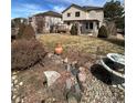 Landscaped backyard with deck and fountain at 24456 E Louisiana Cir, Aurora, CO 80018