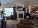 Spacious living room featuring a fireplace and large windows at 18088 Becket Dr, Parker, CO 80134