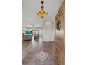 Bright and spacious entryway with tile flooring and a view into the living room at 6001 S County Road 161, Strasburg, CO 80136