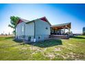 Side view of ranch home showcasing a covered patio and fenced area at 6751 S County Road 129, Bennett, CO 80102