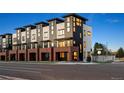 Modern townhome development with brick and metal siding, showcasing sleek architecture at 2164 Applewood Dr, Lakewood, CO 80215