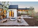 Modern backyard patio with fire pit and seating area, surrounded by landscaping at 5922 37Th Pl, Wheat Ridge, CO 80212