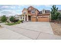 Two-story house with attached garage and front yard at 20052 W 95Th Pl, Arvada, CO 80007