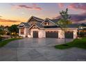 Luxury home with a large driveway and an inviting front yard at 6571 S Harlan Ct, Littleton, CO 80123