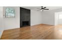 Bright living room featuring hardwood floors and a modern fireplace at 15252 E Hampden Cir # G4, Aurora, CO 80014