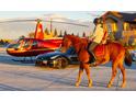 Red helicopter parked near a luxury home and sports car at 12565 Picadilly Rd, Commerce City, CO 80022