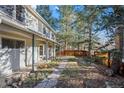 Landscaped side yard with stone walkway and wooden fence at 3644 Fourmile Canyon Dr, Boulder, CO 80302