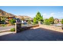 Brick patio with wrought iron fencing, showcasing neighborhood views and landscaping at 7912 Galileo Way, Littleton, CO 80125