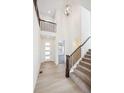 Bright entryway with high ceilings, staircase, and hardwood floors at 1010 Joseph Pl, Erie, CO 80026